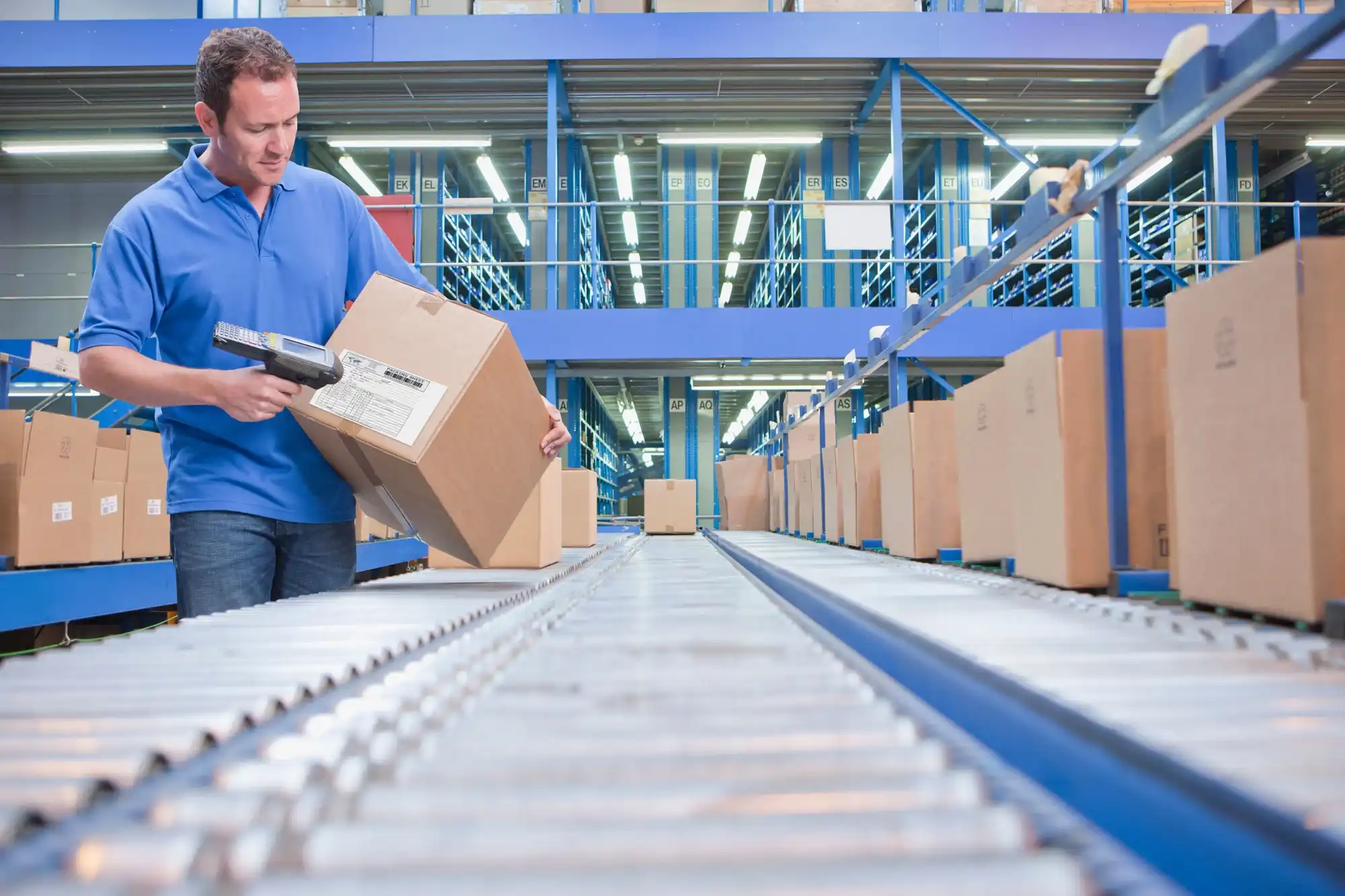 Logistics worker scanning freight in a warehouse